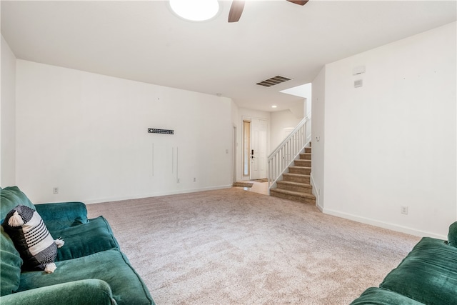 carpeted living room with ceiling fan