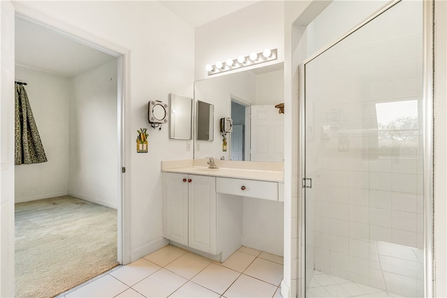 bathroom featuring tile patterned flooring, vanity, and walk in shower