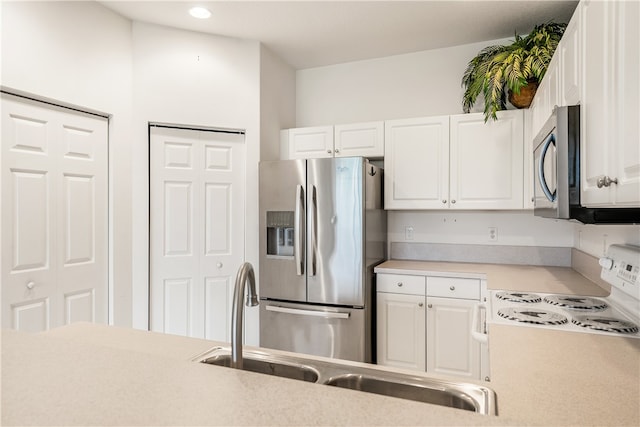 kitchen with white cabinets and appliances with stainless steel finishes