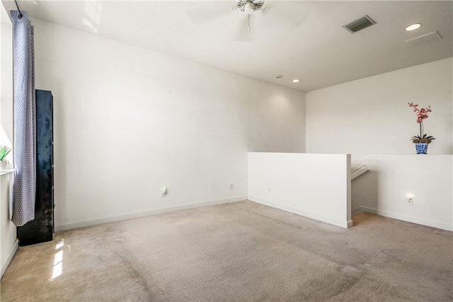 unfurnished room featuring light carpet