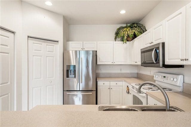 kitchen featuring white cabinets, stainless steel appliances, and sink