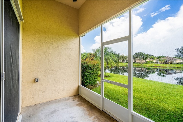 unfurnished sunroom featuring plenty of natural light and a water view