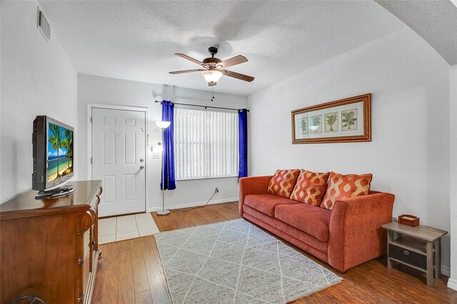 living room with ceiling fan and light hardwood / wood-style floors