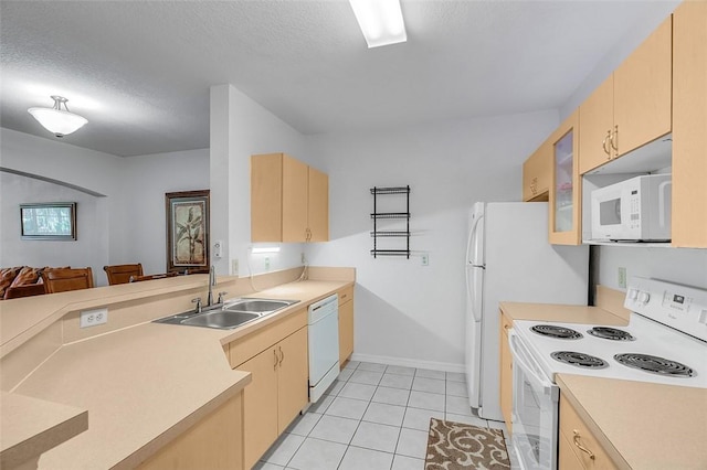 kitchen with white appliances, sink, a textured ceiling, and light brown cabinets