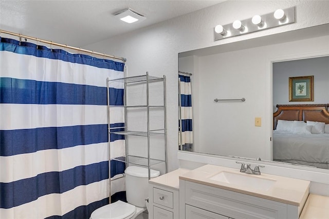 bathroom featuring vanity, a shower with curtain, and toilet