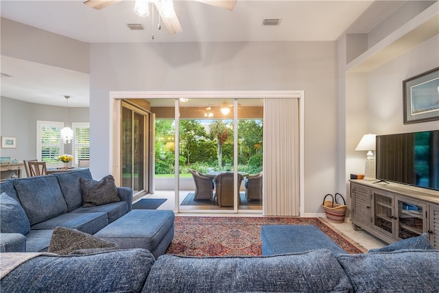 living room featuring light tile patterned floors and ceiling fan