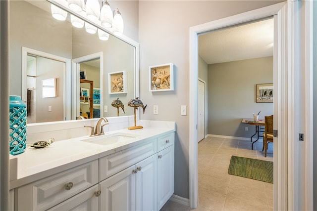 bathroom with tile patterned flooring, vanity, and a textured ceiling