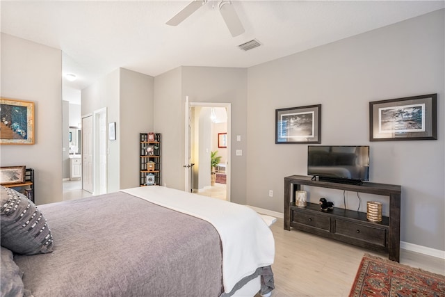 bedroom featuring ensuite bathroom, light hardwood / wood-style flooring, and ceiling fan