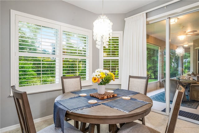 dining space with a notable chandelier, light tile patterned floors, and plenty of natural light