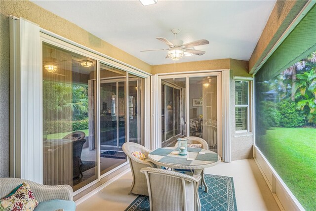 sunroom featuring ceiling fan