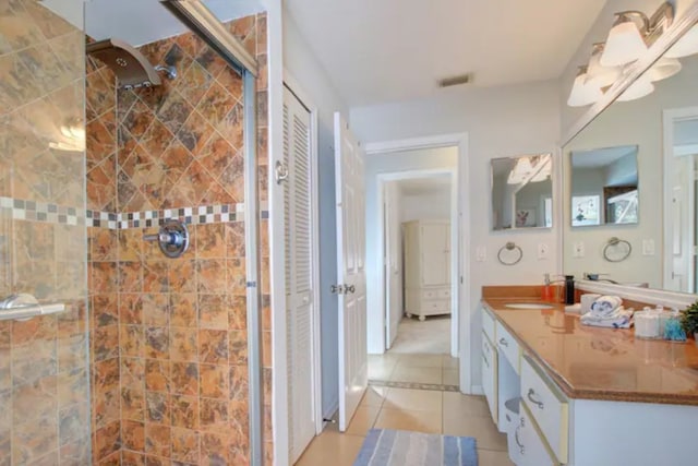 full bath featuring tile patterned floors, visible vents, a stall shower, and vanity