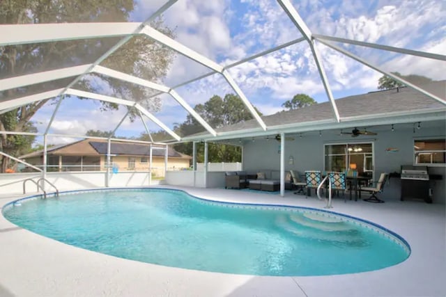 outdoor pool with glass enclosure, ceiling fan, outdoor lounge area, and a patio area