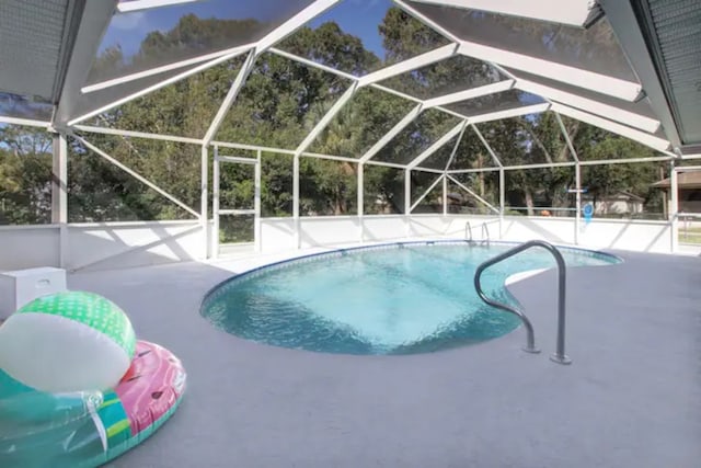 outdoor pool featuring a lanai and a patio area