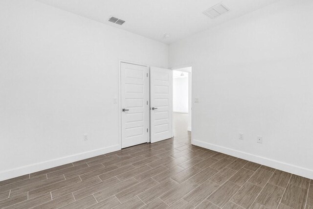 8050 96th Ave, Vero Beach, FL 32967 - empty room featuring wood finished floors and baseboards