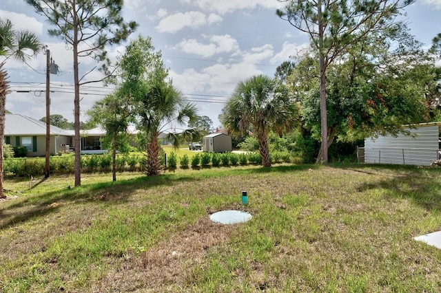 8050 96th Ave, Vero Beach, FL 32967 - view of grassy yard featuring a storage unit and an outdoor structure