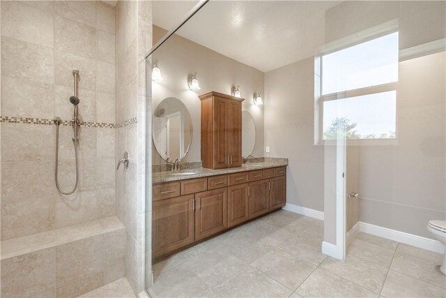 5964 Long Leaf Ln, Vero Beach, FL 32966 - full bathroom with a walk in shower, double vanity, toilet, baseboards, and tile patterned floors