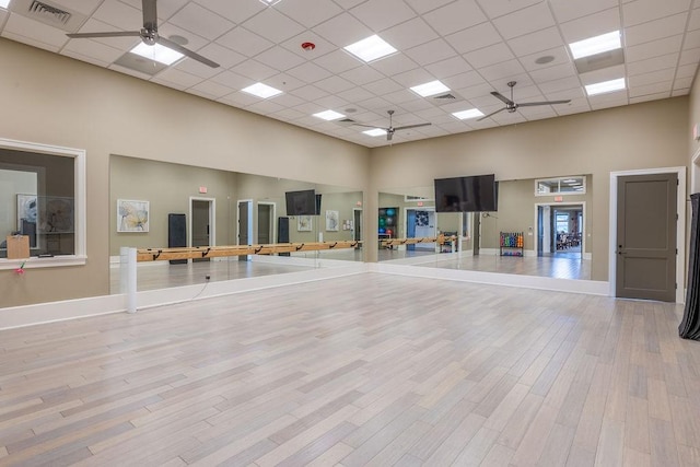 5964 Long Leaf Ln, Vero Beach, FL 32966 - workout area featuring a high ceiling, ceiling fan, wood finished floors, baseboards, and a drop ceiling