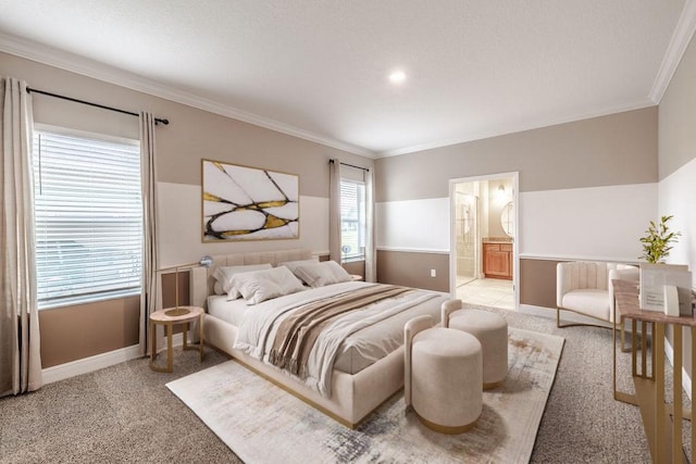 bedroom featuring ensuite bathroom, crown molding, and light colored carpet