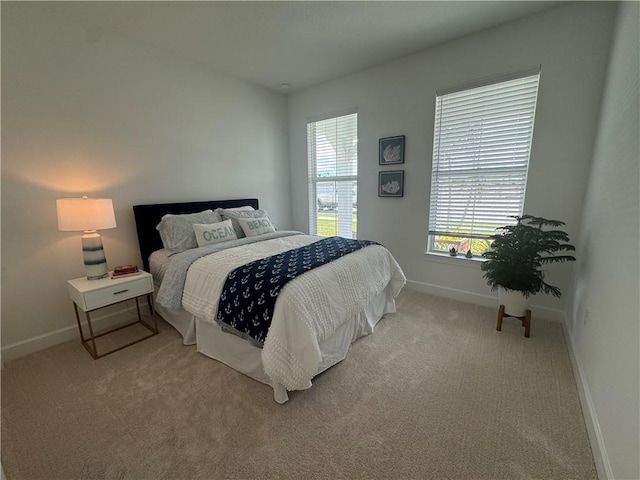 bedroom with carpet flooring and baseboards