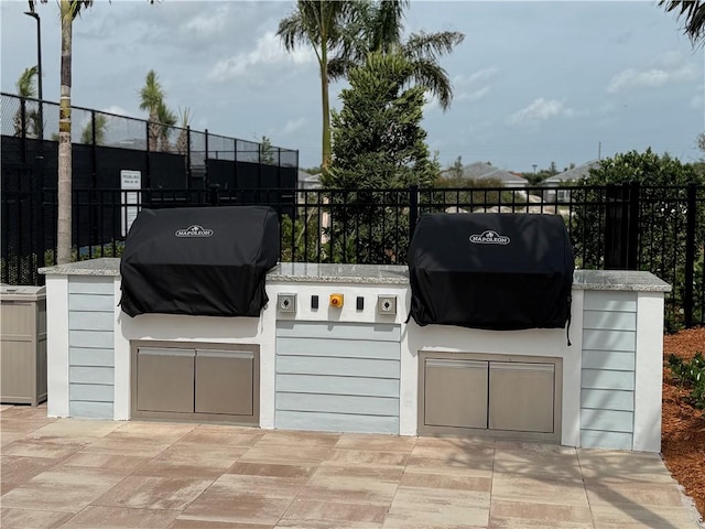 view of patio / terrace with fence and area for grilling