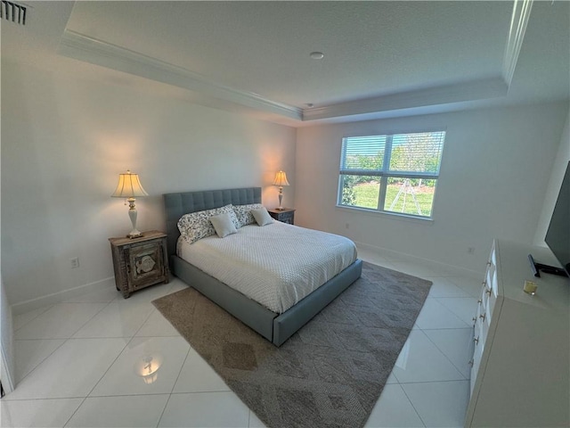 bedroom featuring a raised ceiling, visible vents, ornamental molding, tile patterned flooring, and baseboards