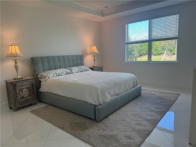 bedroom featuring baseboards, ornamental molding, a raised ceiling, and tile patterned floors