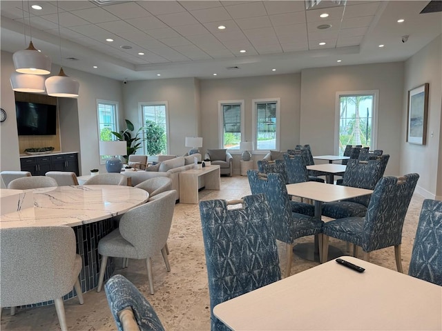 dining area with baseboards, a drop ceiling, and recessed lighting