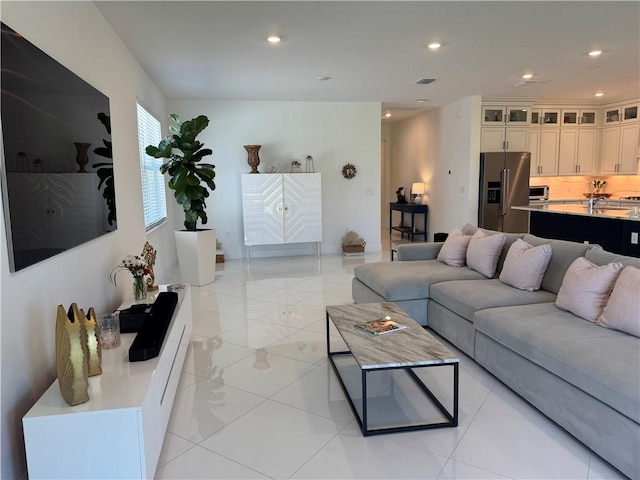 living area with visible vents and recessed lighting