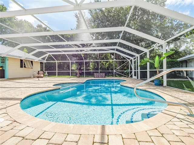 view of swimming pool with glass enclosure and a patio