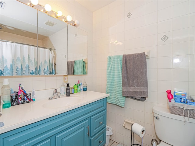 bathroom featuring decorative backsplash, vanity, tile walls, toilet, and curtained shower