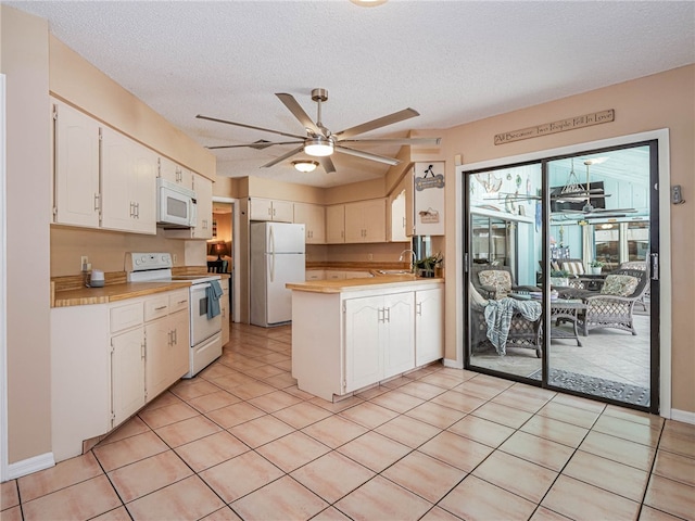 kitchen featuring white appliances, sink, ceiling fan, a textured ceiling, and white cabinetry