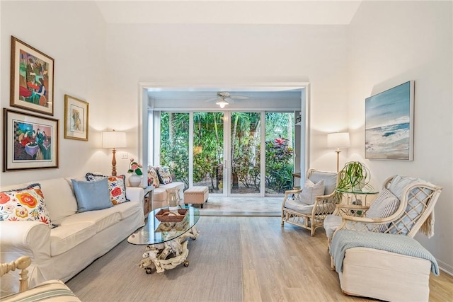 living room featuring ceiling fan and light hardwood / wood-style floors