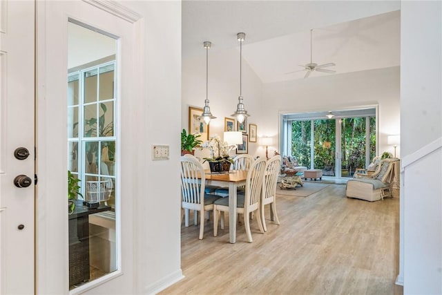 dining area featuring light hardwood / wood-style flooring, ceiling fan, and lofted ceiling