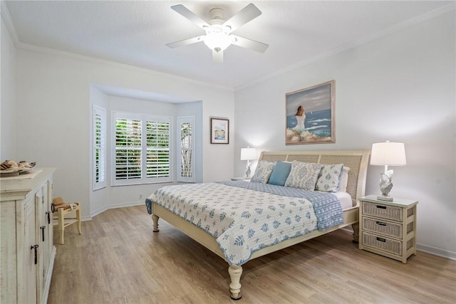 bedroom with ceiling fan, ornamental molding, and light wood-type flooring