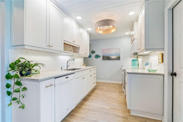 kitchen with light wood-type flooring, white appliances, white cabinetry, and sink