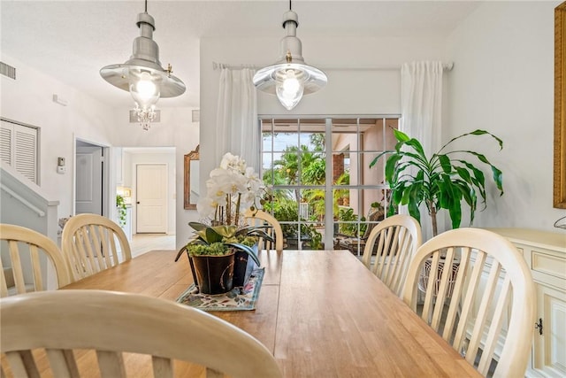 dining space with an inviting chandelier