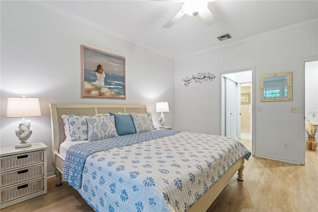 bedroom with hardwood / wood-style floors, ceiling fan, and ornamental molding