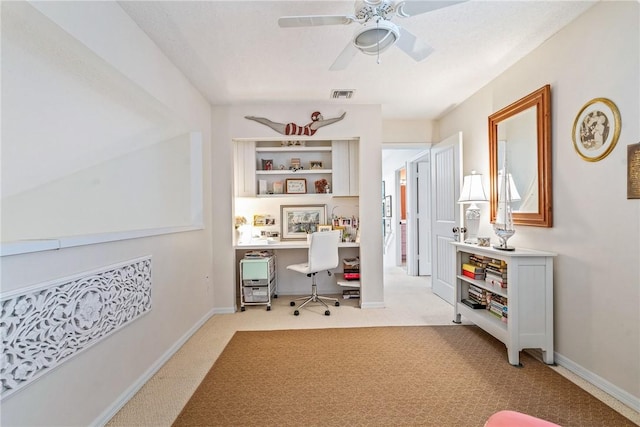 carpeted office with ceiling fan