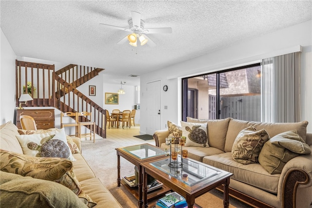 living room with ceiling fan, a textured ceiling, and carpet floors