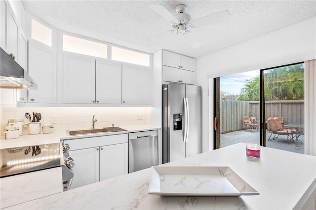 kitchen featuring tasteful backsplash, white cabinetry, sink, and stainless steel appliances