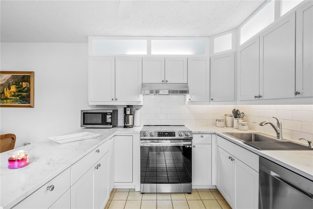 kitchen featuring white cabinetry, stainless steel appliances, and backsplash