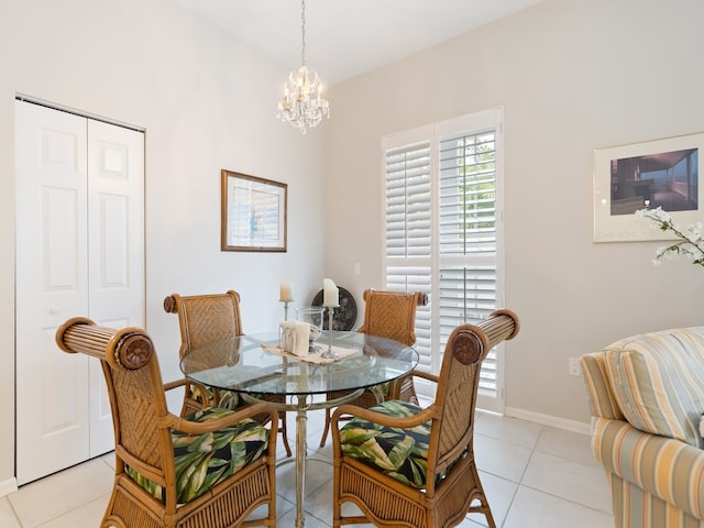 dining area with a notable chandelier and light tile patterned flooring