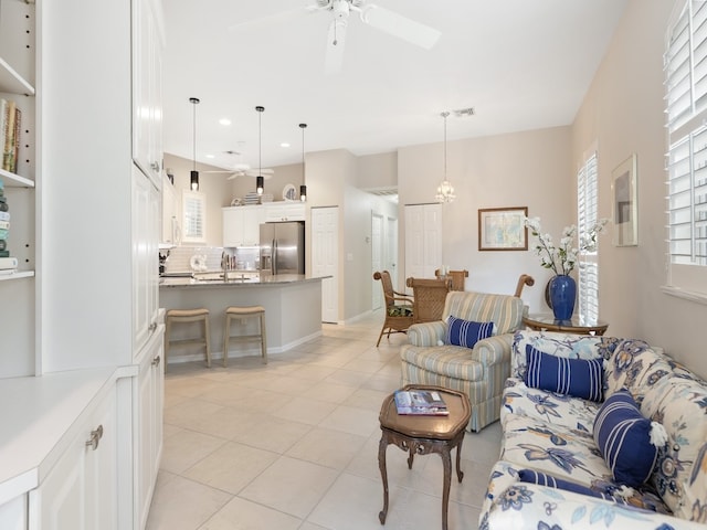 living room with ceiling fan and light tile patterned floors