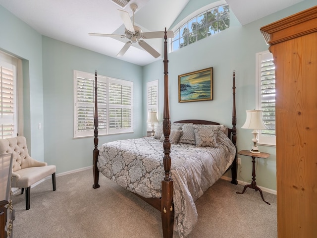 bedroom featuring ceiling fan, light carpet, and multiple windows