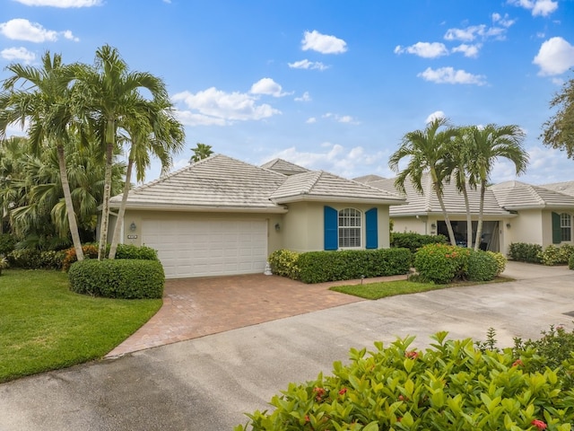 single story home with a front yard and a garage