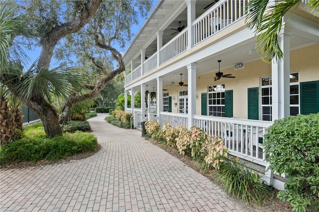 exterior space with ceiling fan and a balcony