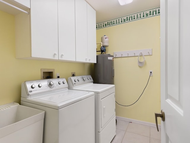 washroom featuring sink, cabinets, water heater, independent washer and dryer, and light tile patterned floors