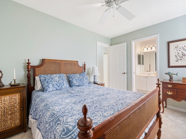 bedroom with ensuite bath, ceiling fan, and light carpet