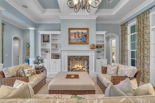 411 S Palm Island Cir, Vero Beach, FL 32963 - living room featuring arched walkways, a chandelier, ornamental molding, a premium fireplace, and built in features