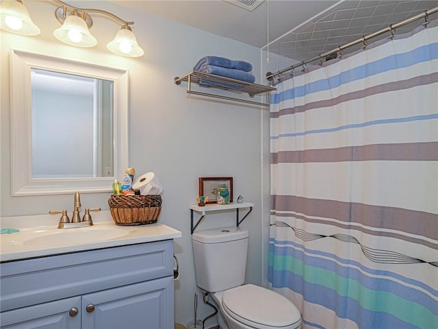 bathroom with vanity, toilet, and a shower with curtain